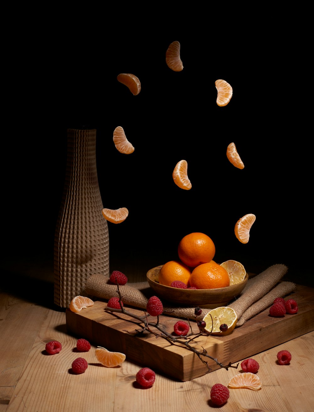 a wooden table topped with a bowl of fruit