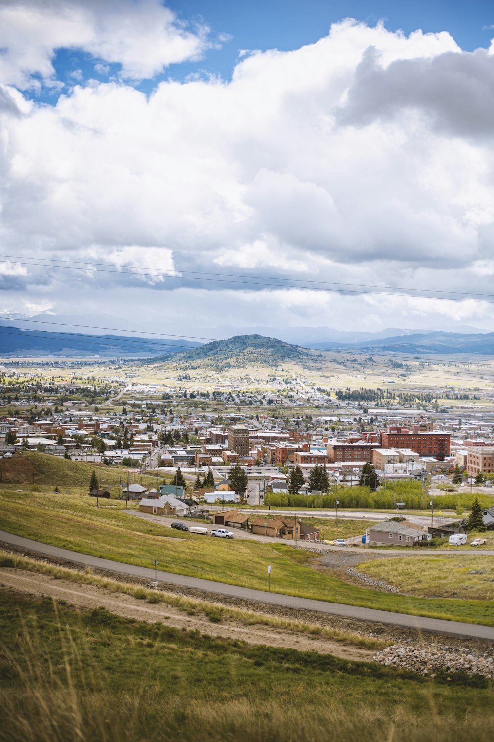 a scenic view of a city with mountains in the background