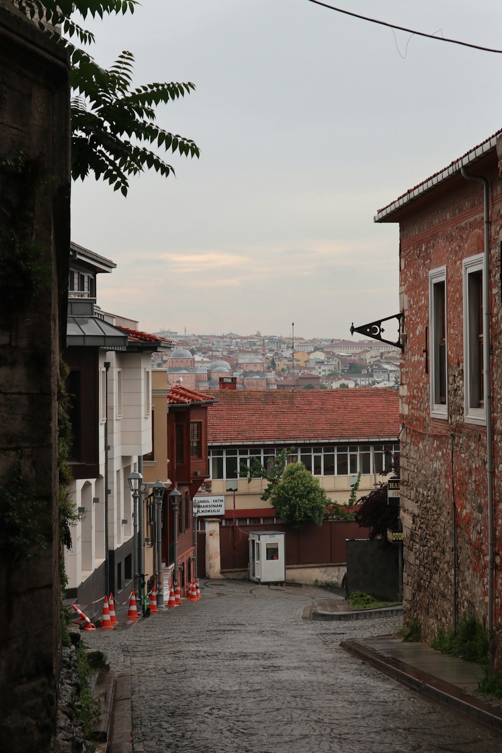 an alley way with a brick building and a view of a city