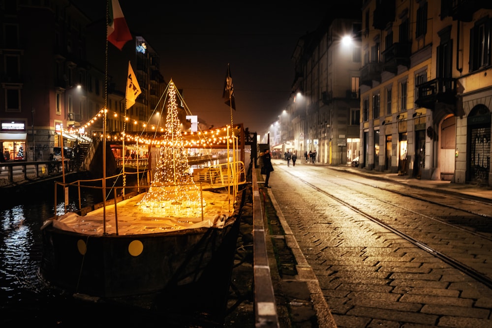 a boat with a christmas tree on it in the middle of a street