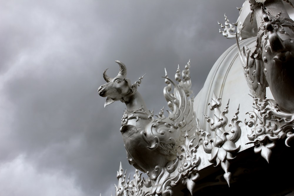 a white and black photo of a building with statues on it