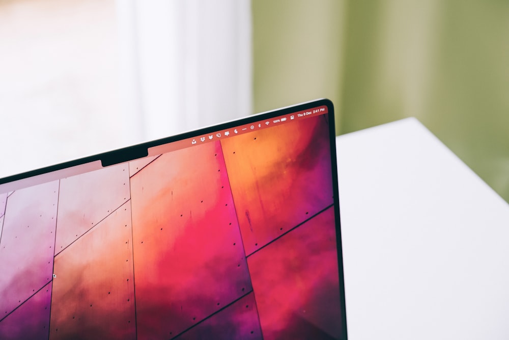 a laptop computer sitting on top of a white desk