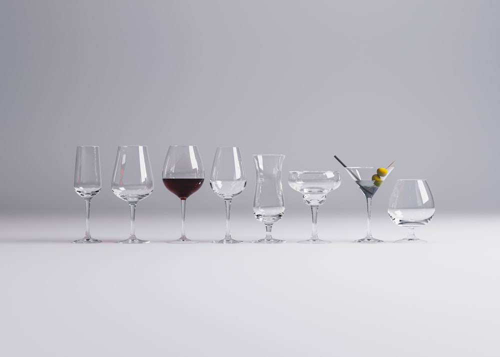 a row of wine glasses sitting next to each other