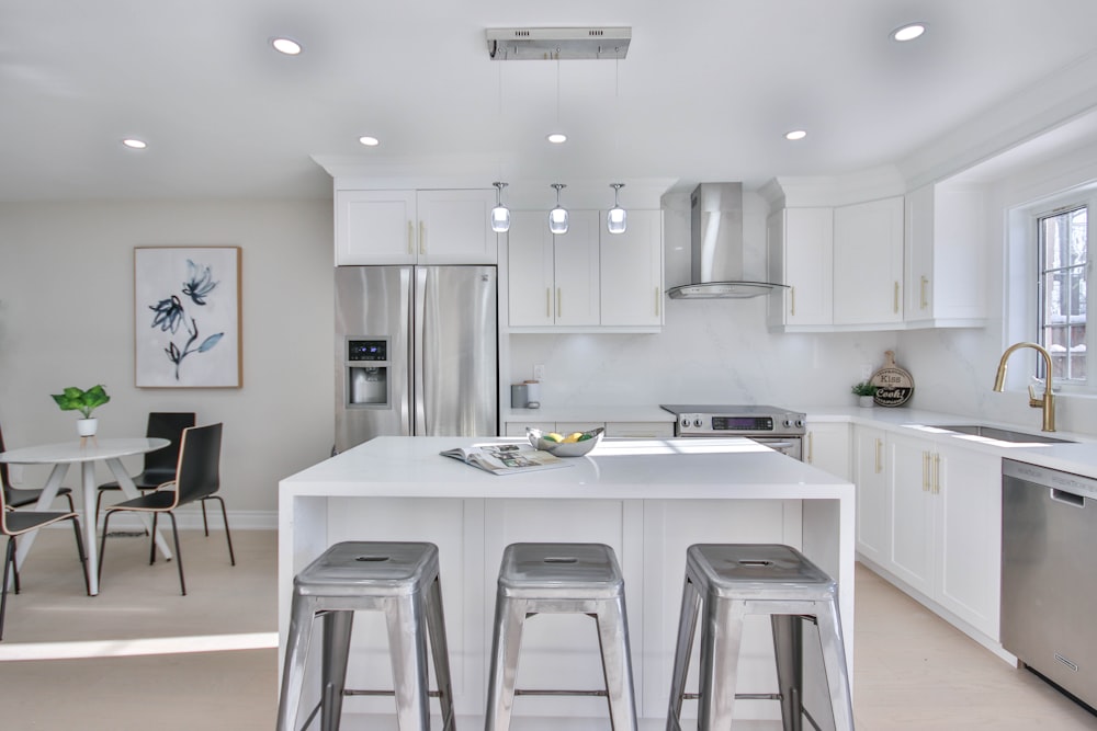 a kitchen with a center island with stools