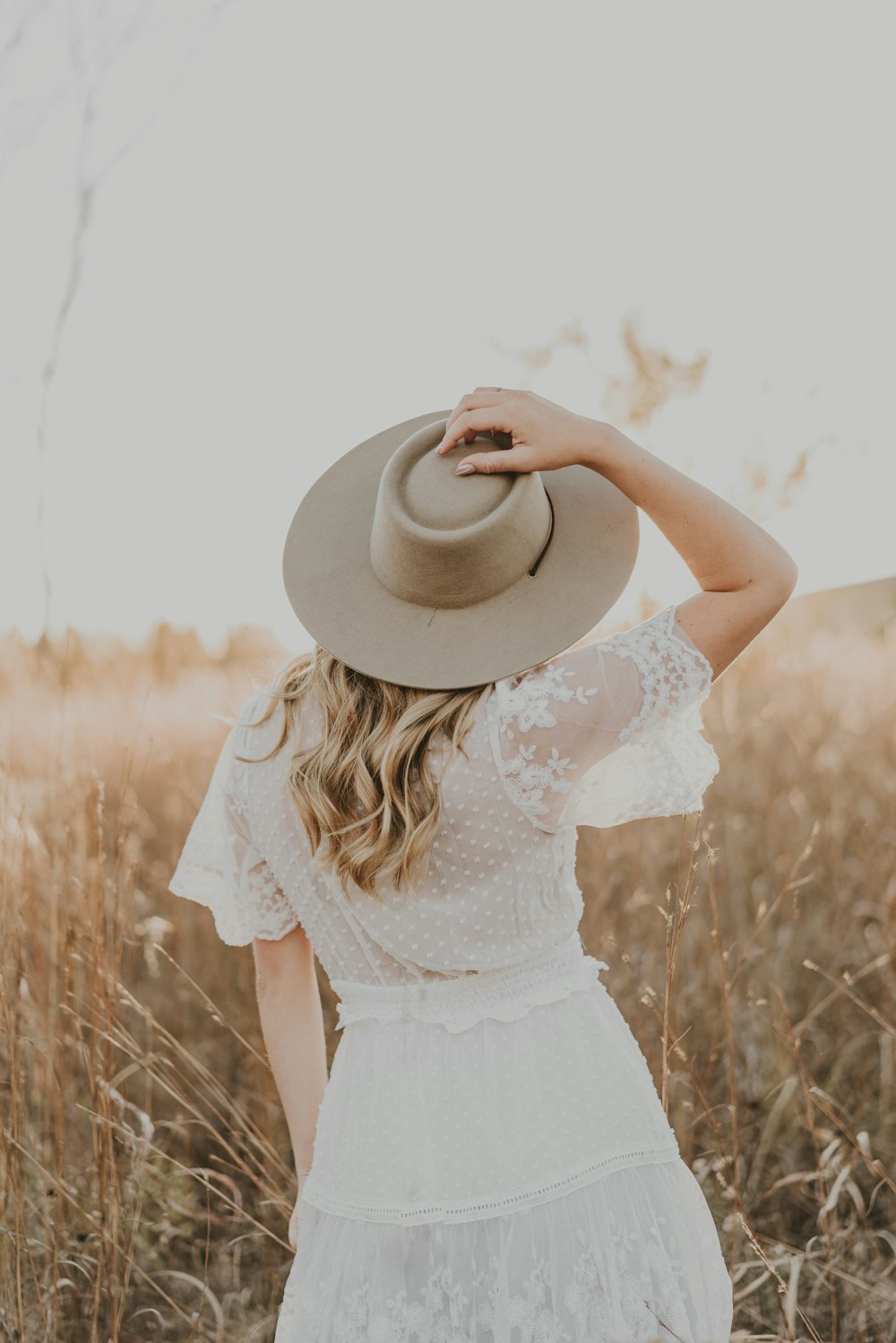 a woman wearing a hat in a field