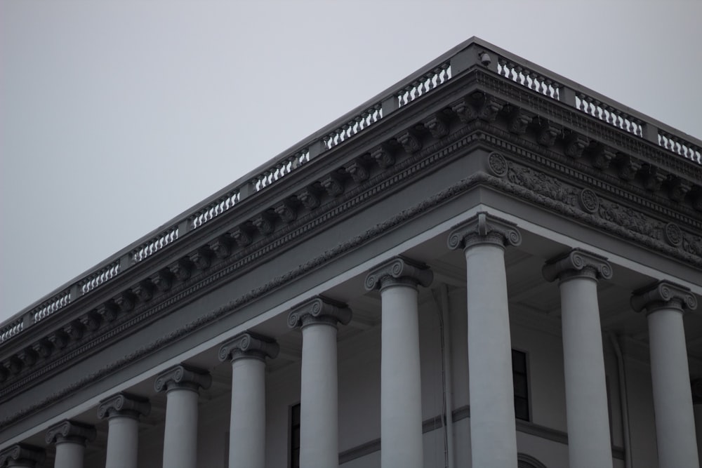 a close up of the top of a building with columns