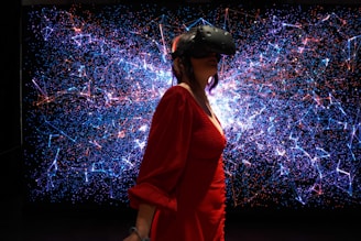 a woman in a red dress wearing a virtual reality headset