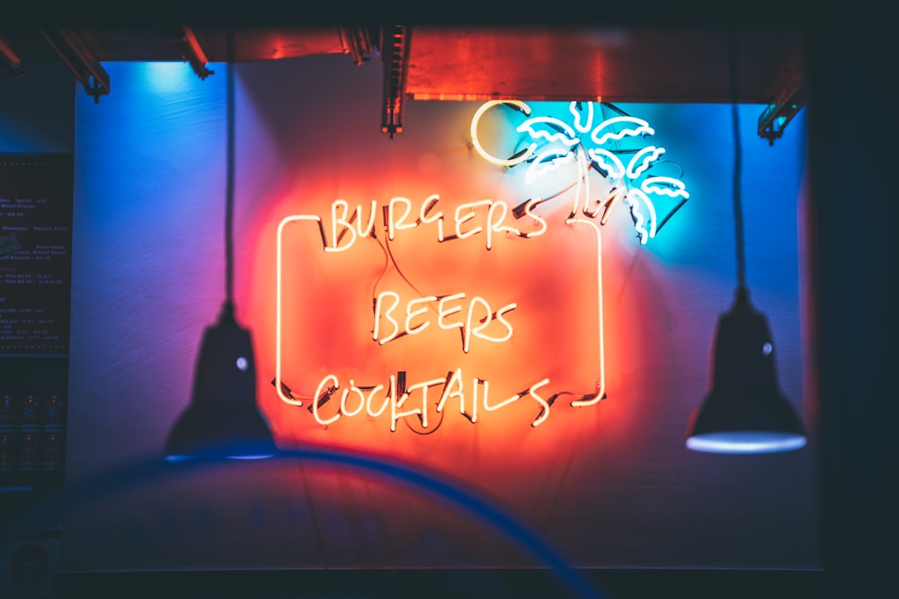 a neon sign that reads burgers keep cocktails