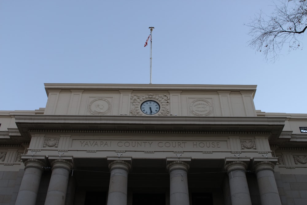 a clock on top of a building with columns