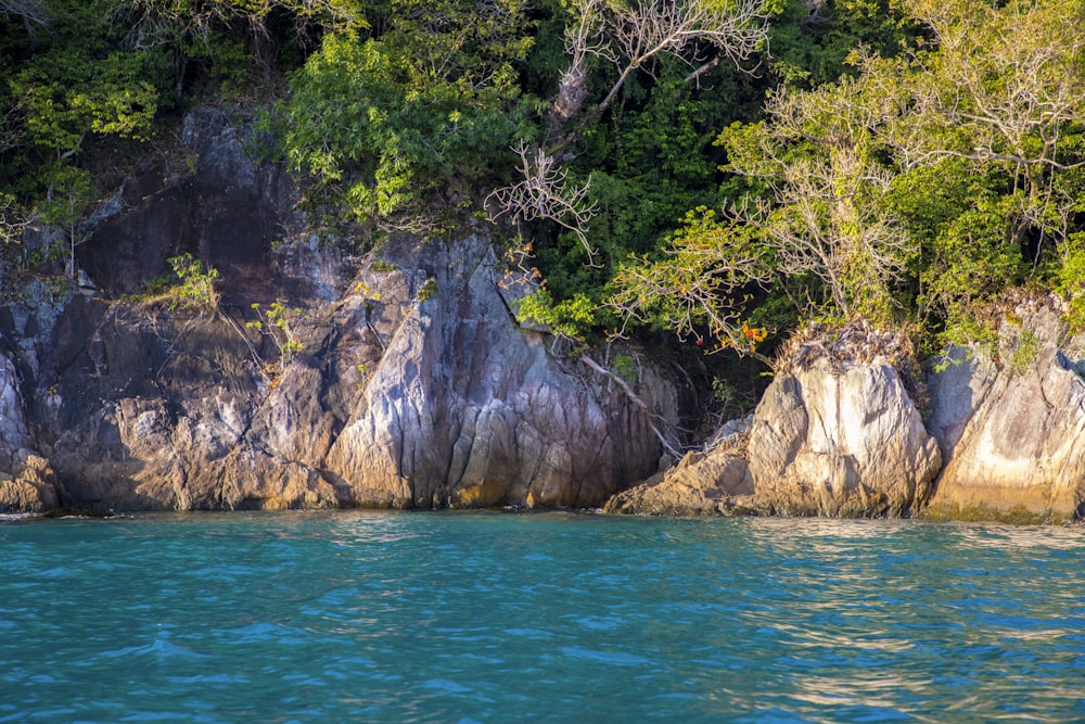 a large rock outcropping next to a body of water