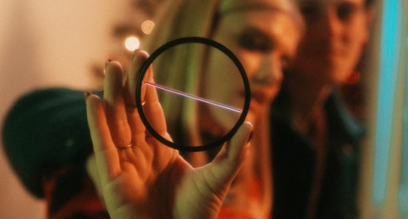 a woman holding a magnifying glass in front of her face