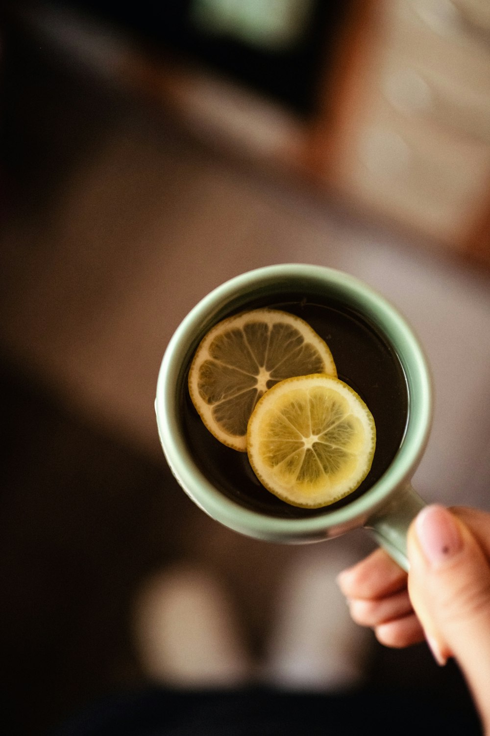 a cup of tea with lemon slices in it