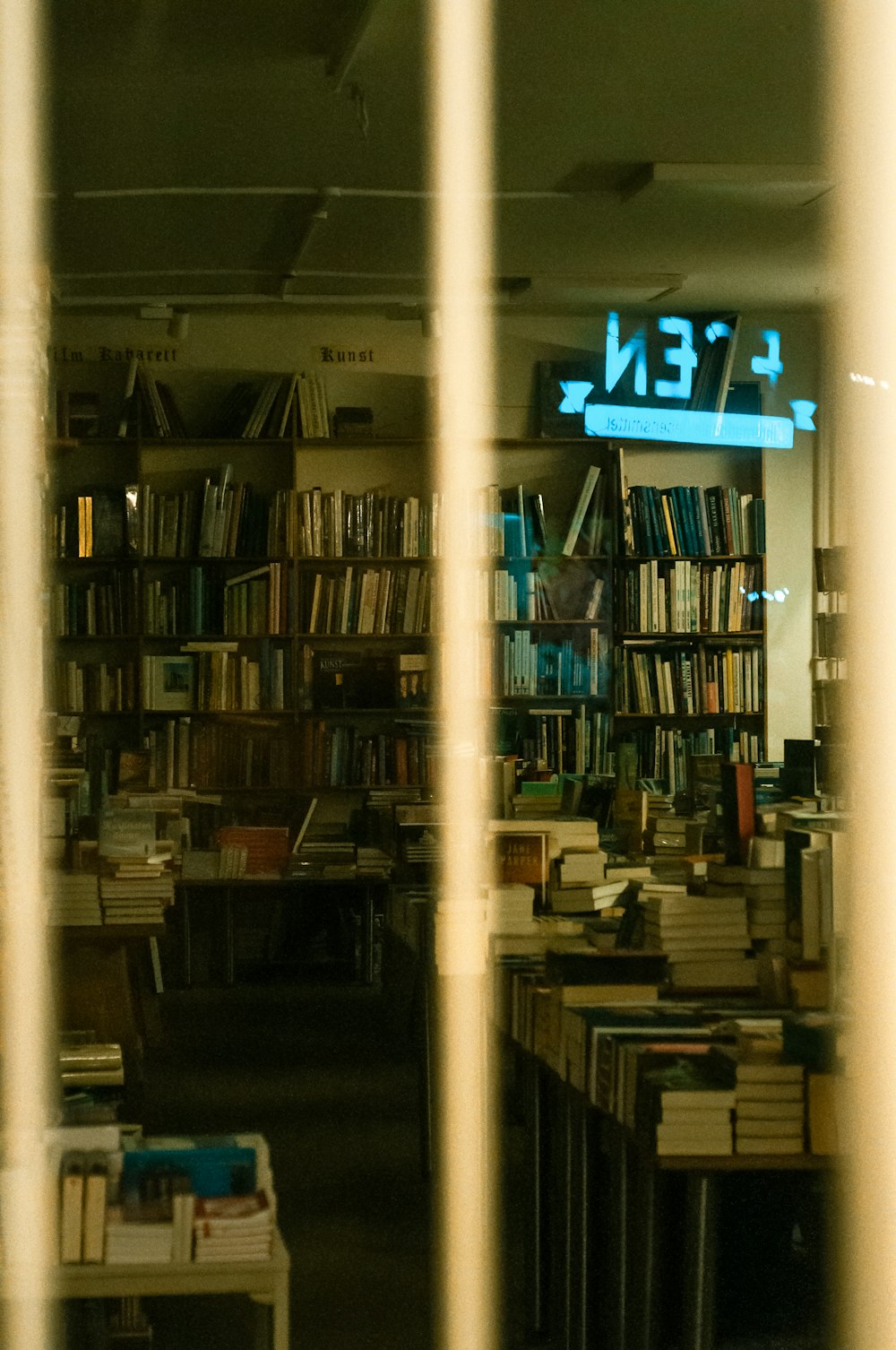 a library filled with lots of books and a neon sign