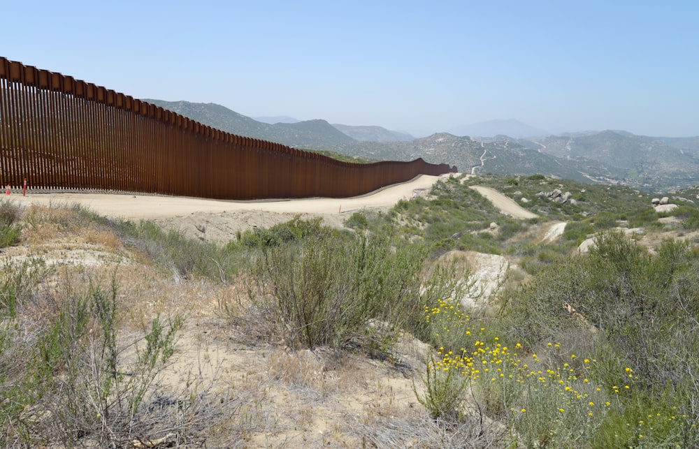 a large metal fence in the middle of a desert