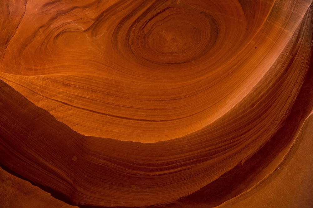 a large rock formation with a wave in the middle of it