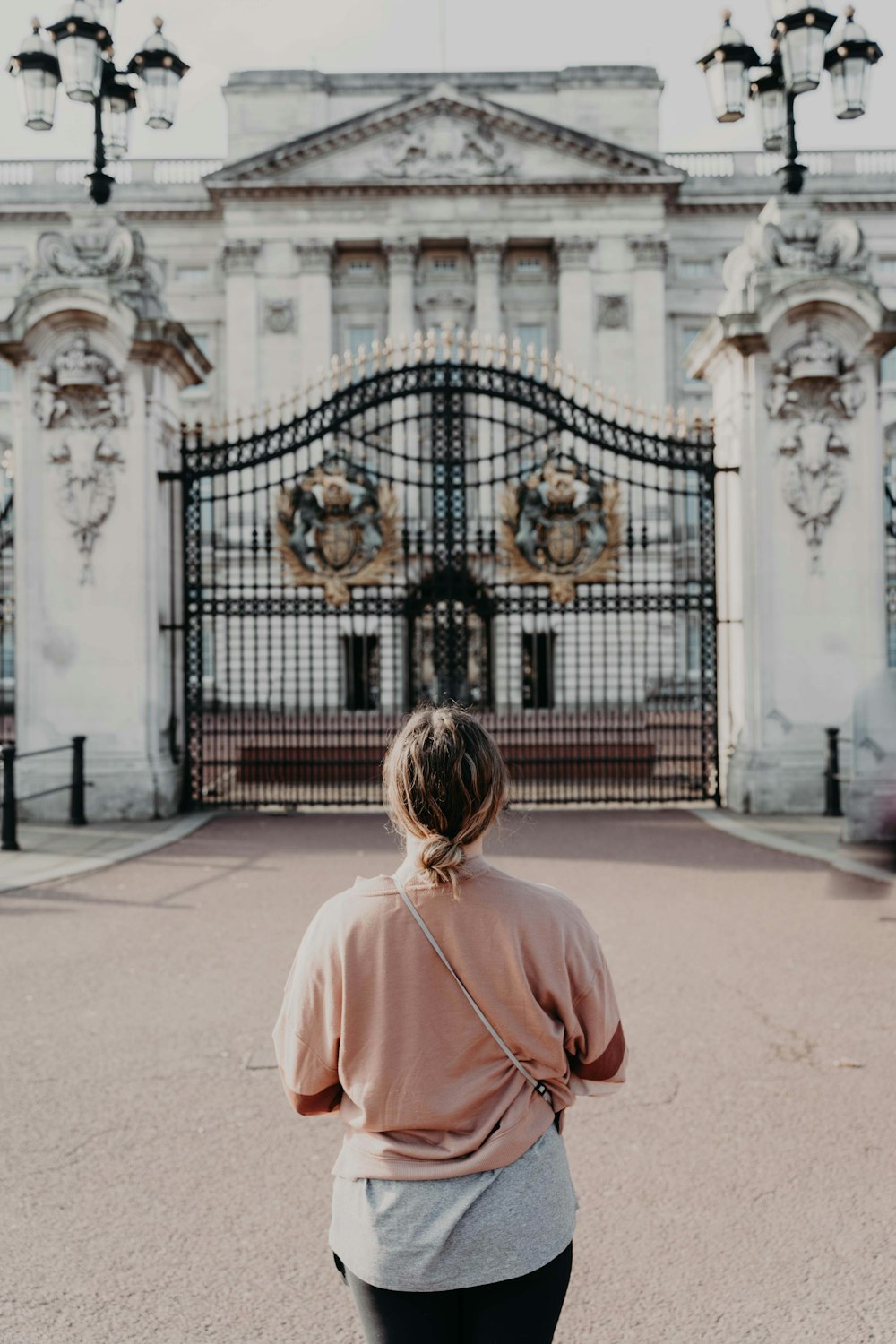 a woman standing in front of a large building