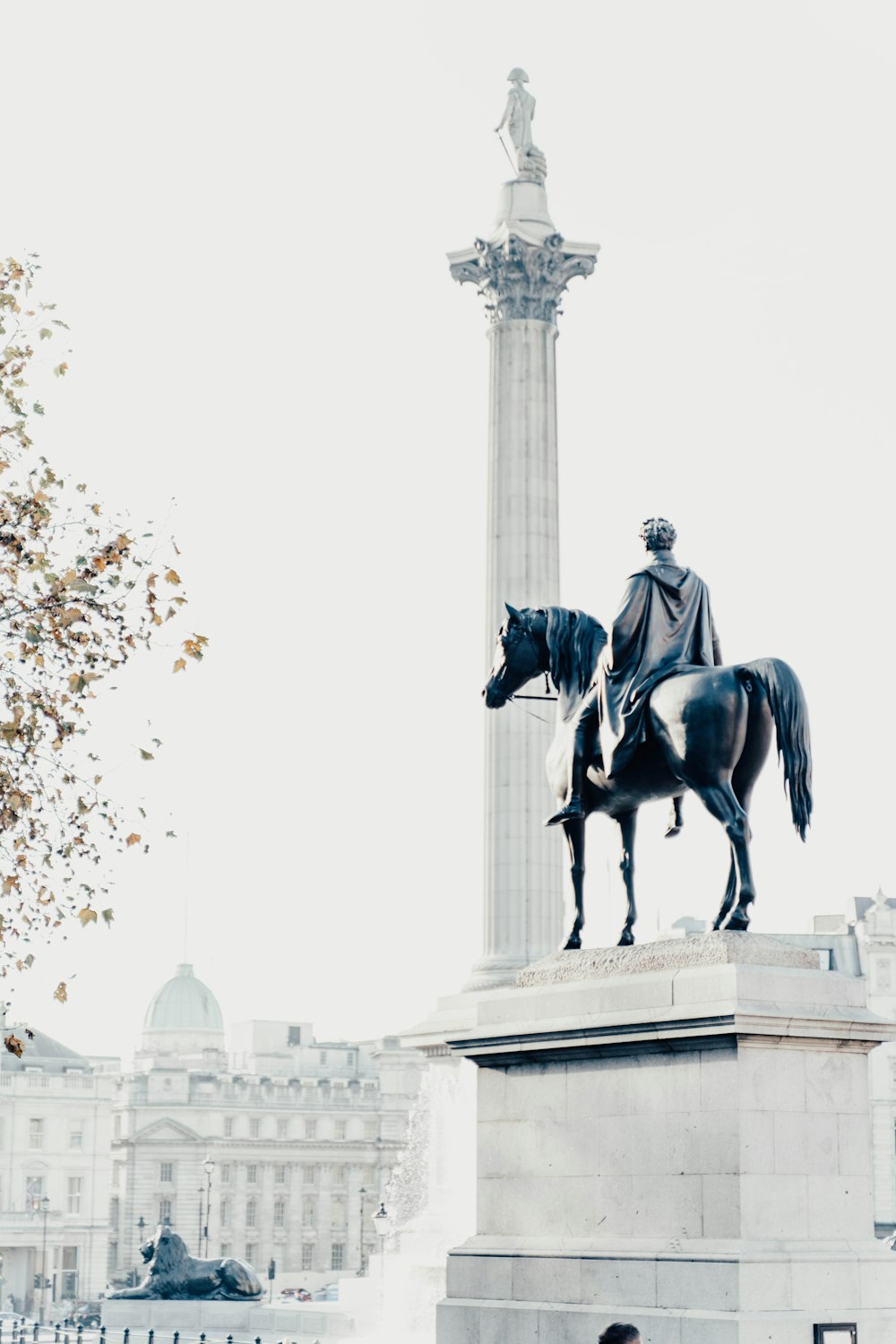 a statue of a man on a horse in front of a building