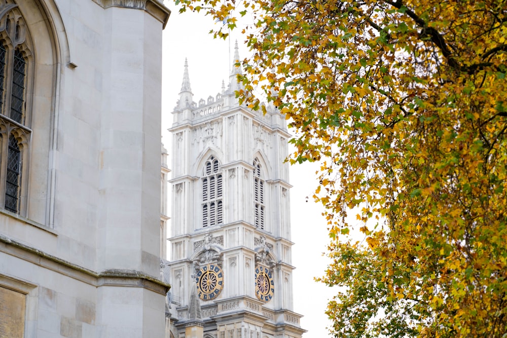 a tall white building with a clock on it's side