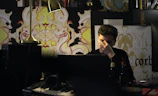 A relaxed portrait of me at my desk, surrounded by notes and a laptop.