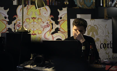 Close-up photo of a staff member working thoughtfully at their desk.