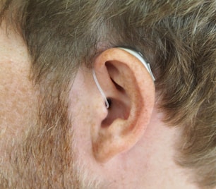 a close up of a man's ear with a pair of earplug