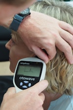 a man getting his hair brushed by a hair stylist