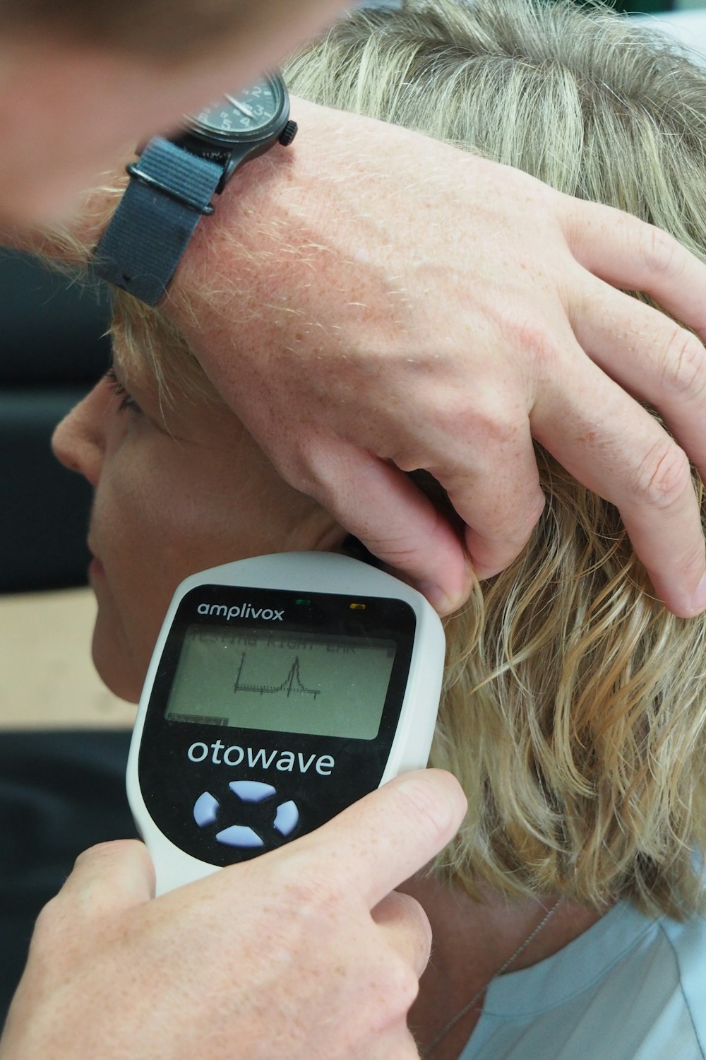 a man getting his hair brushed by a hair stylist