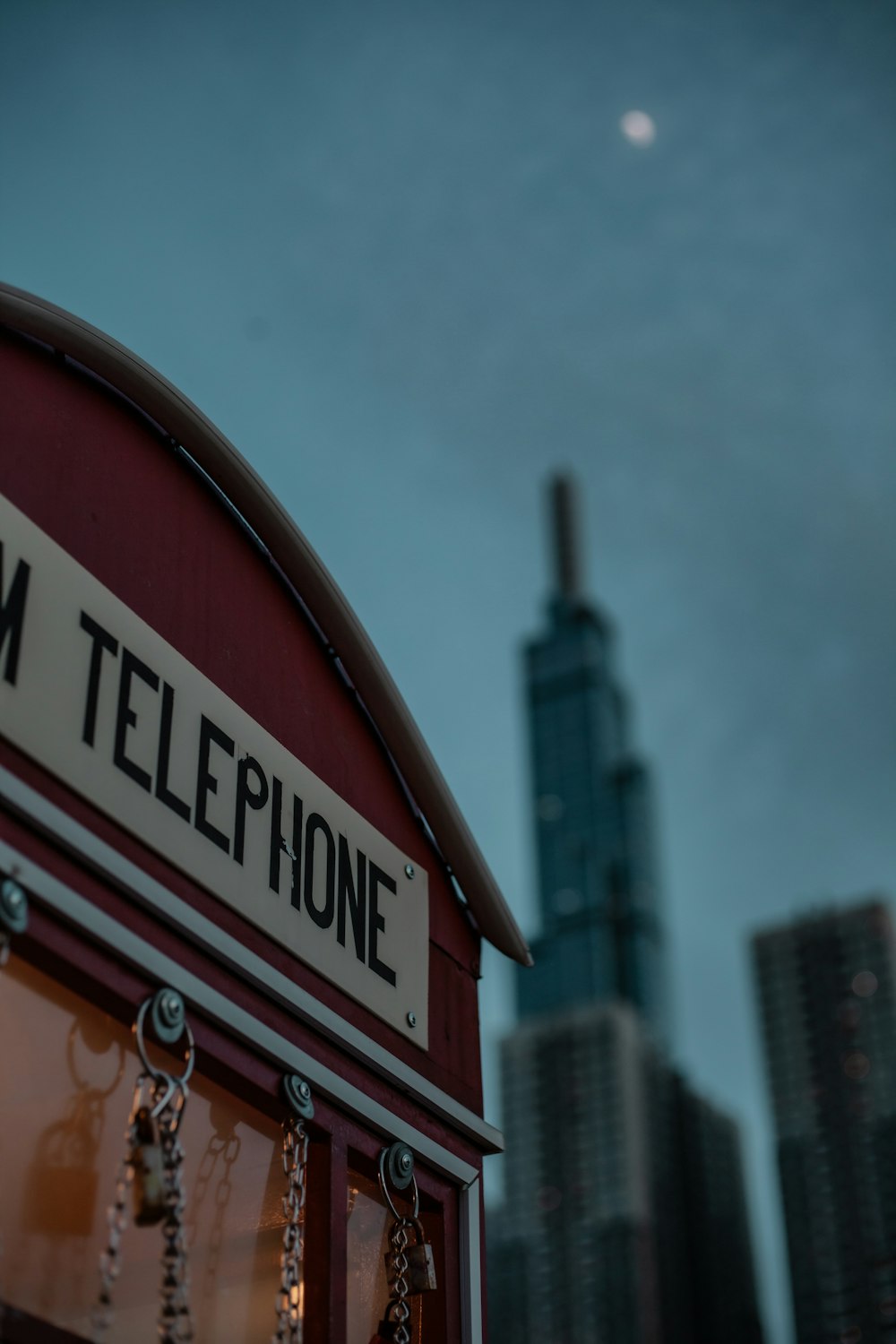 a telephone booth with a city in the background