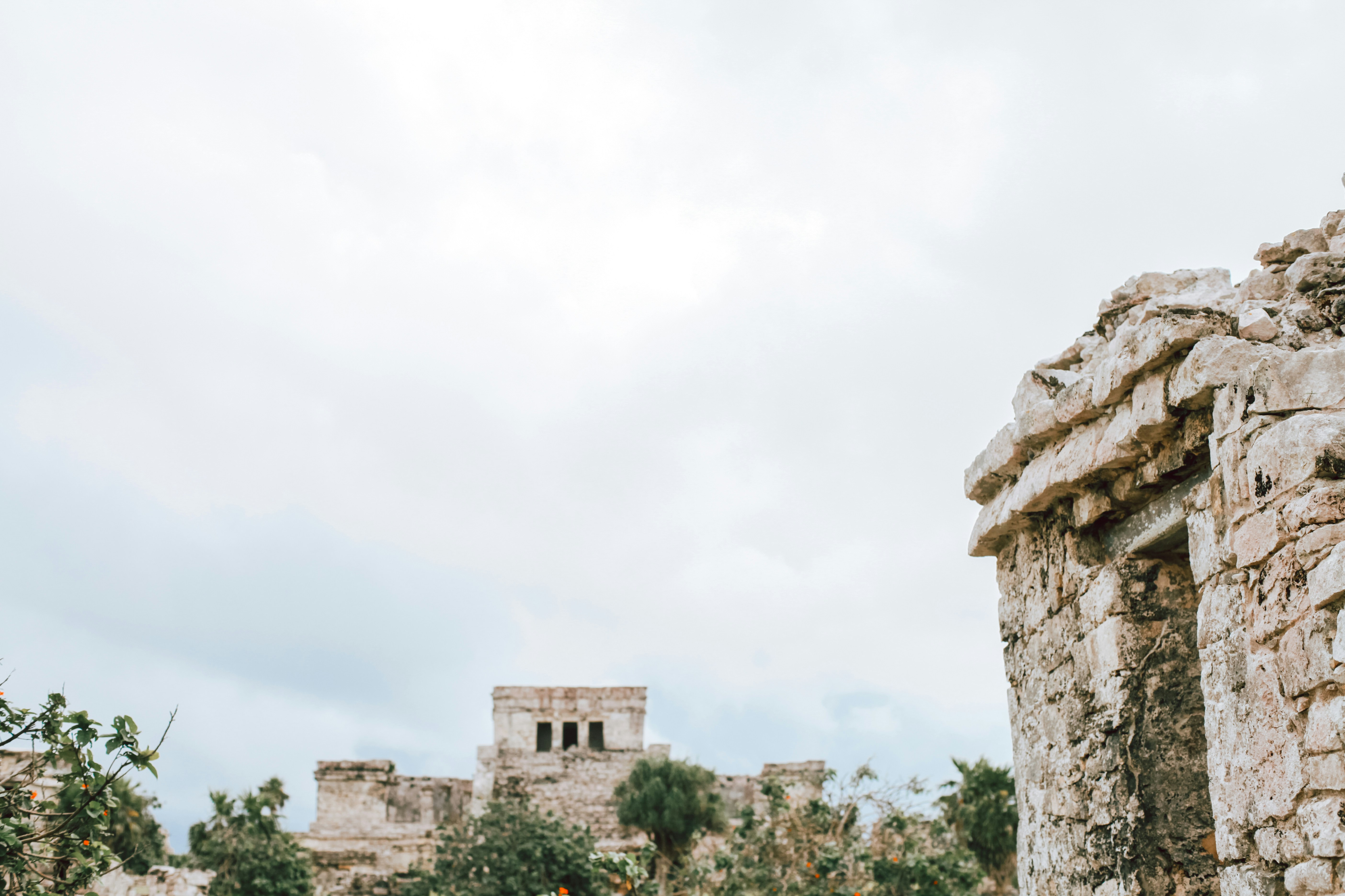 una struttura in pietra con una torre dell'orologio sullo sfondo