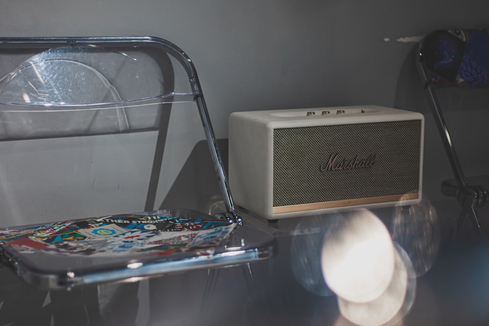 a white radio sitting on top of a glass table
