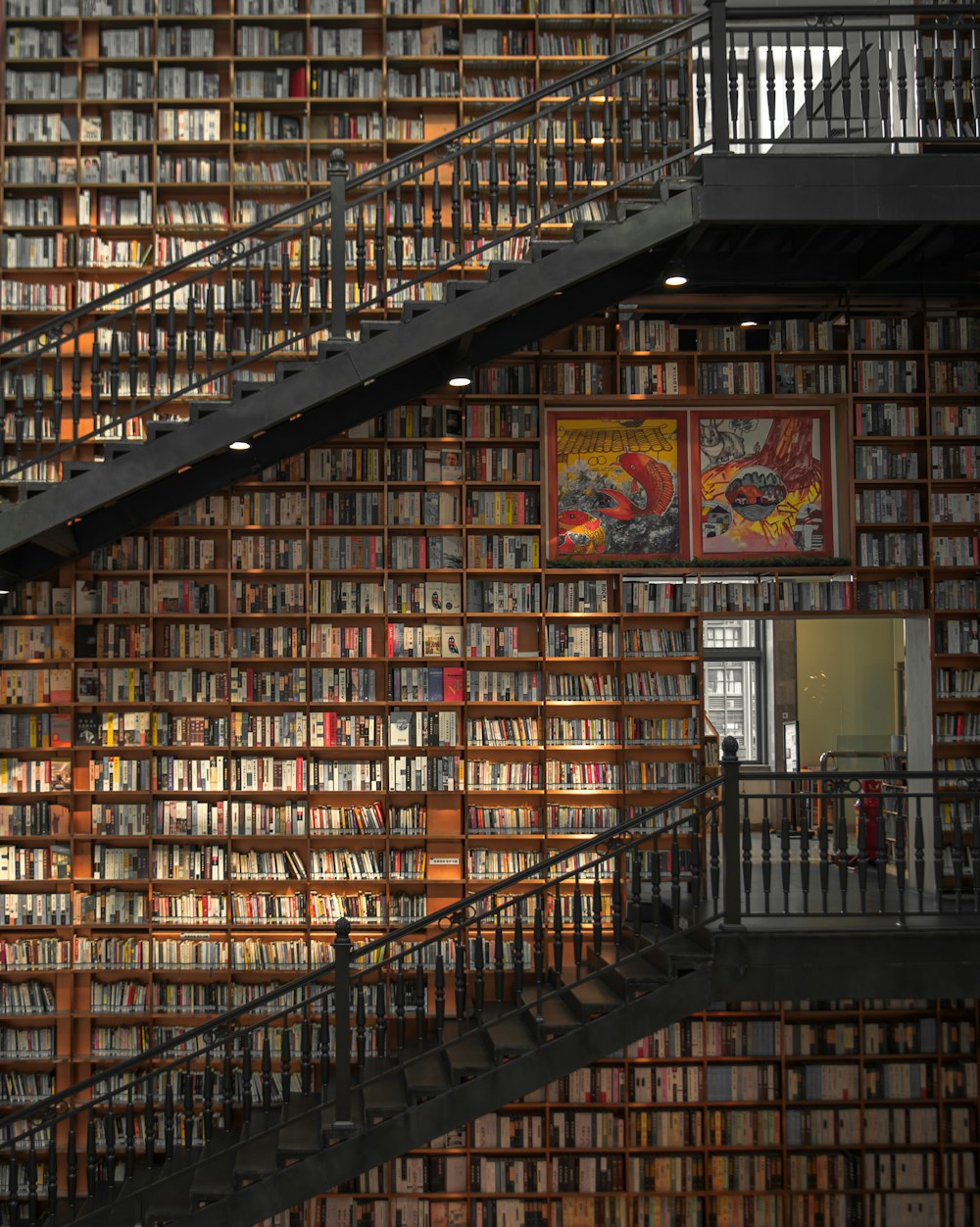 a staircase leading up to a bookshelf full of books