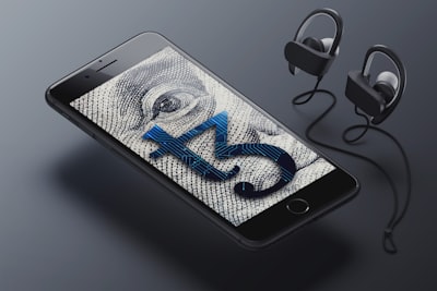 a cell phone with ear buds connected to it