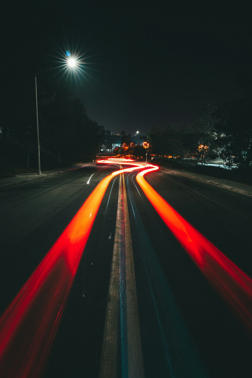 a long exposure photo of a city street at night