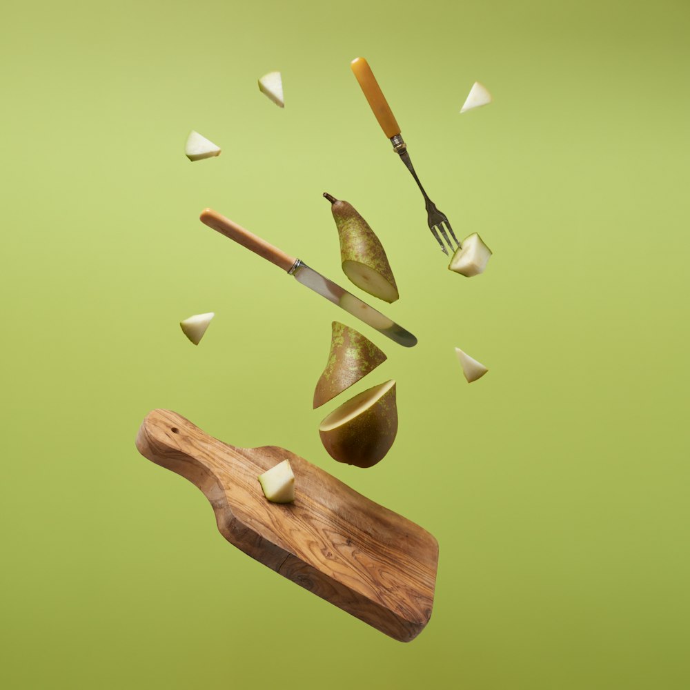 a wooden cutting board with a knife and some food on top of it