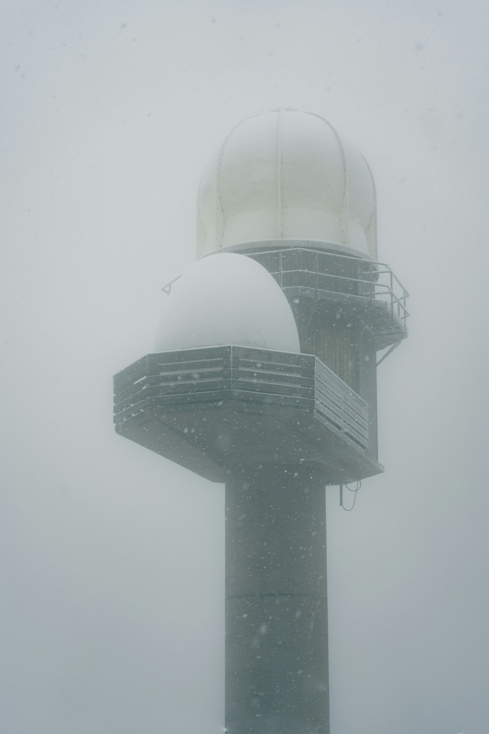 a very tall tower with a clock on it's side