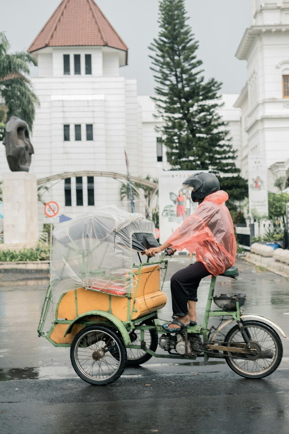 a person riding a bike with an umbrella on the back