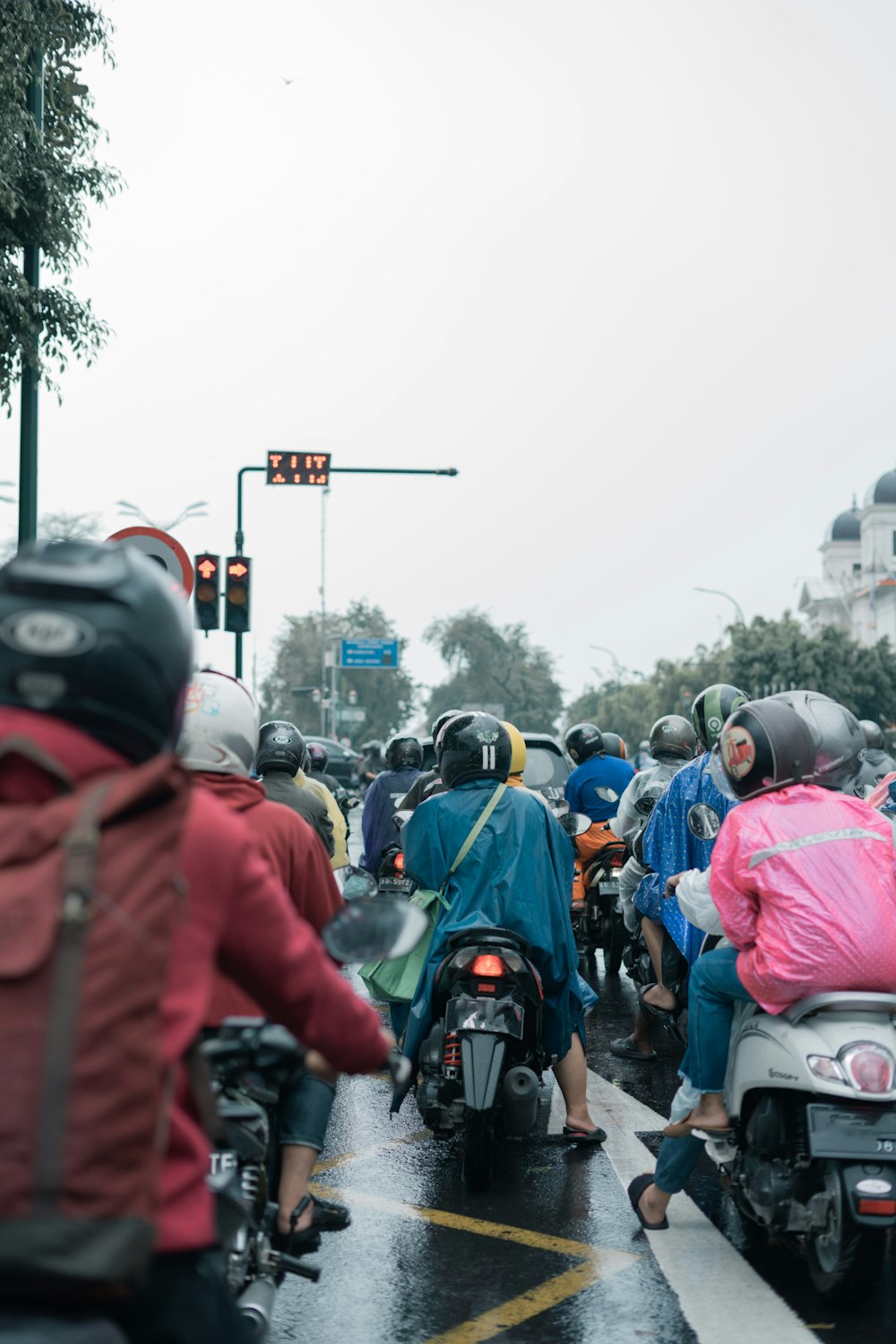 a group of people riding motorcycles down a street