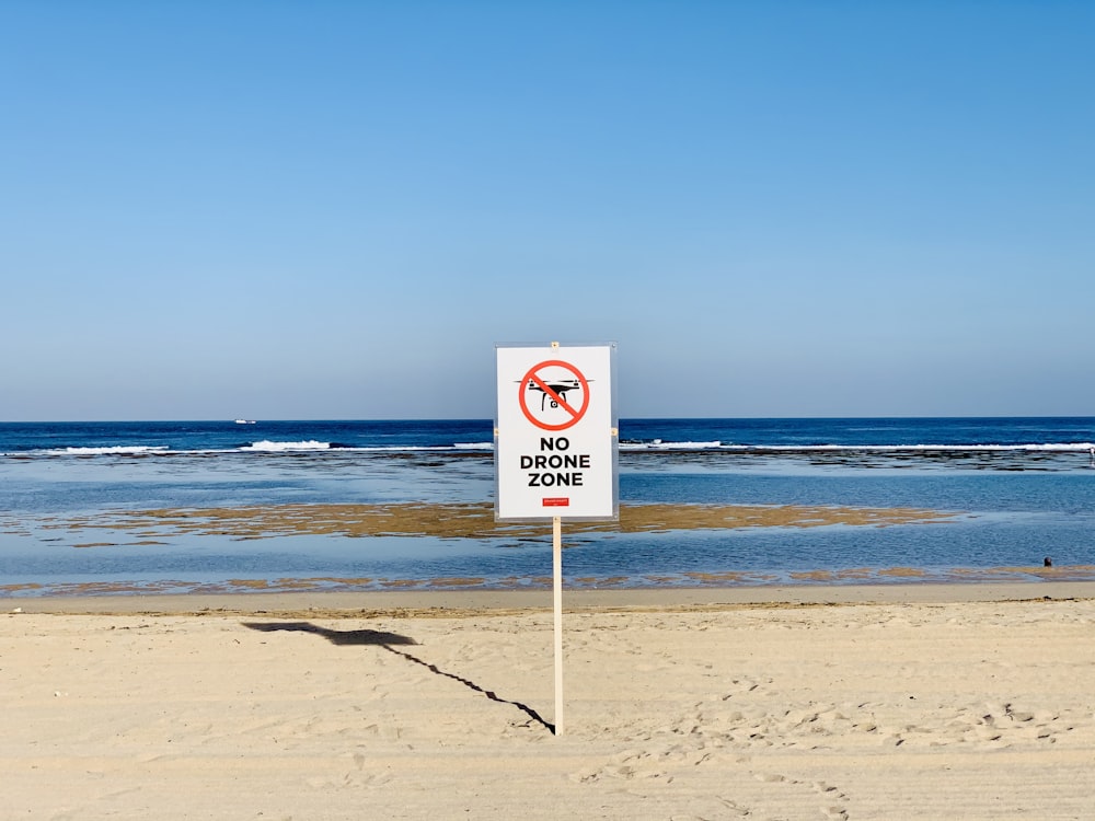 a no dogs allowed sign on a beach