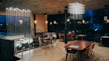 A sleek dining area showcasing elegant tables and chairs with warm lighting.