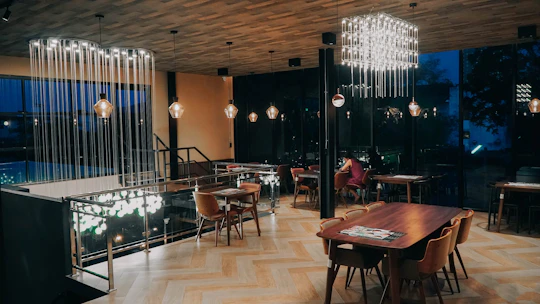 A cozy, modern dining area with minimalist decor and soft lighting highlighting elegant table settings.