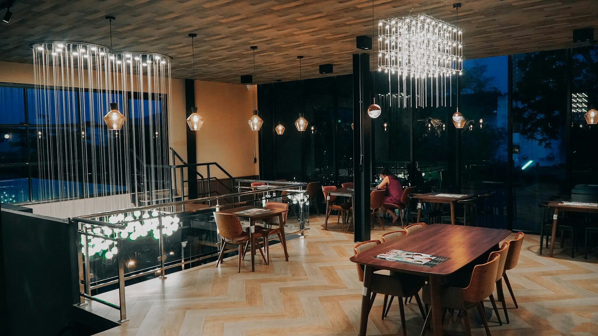 An elegant dining area with a handcrafted wooden table and ambient pendant lighting, reflecting the refined taste of Narvos Services.