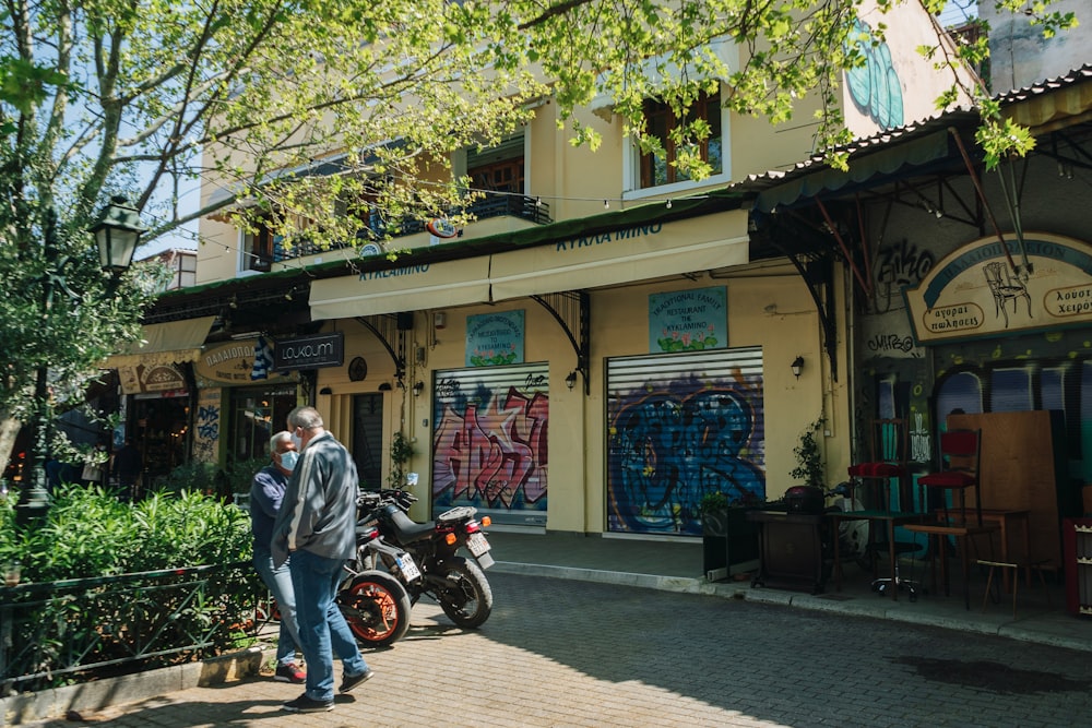 a person riding a motorcycle in front of a store