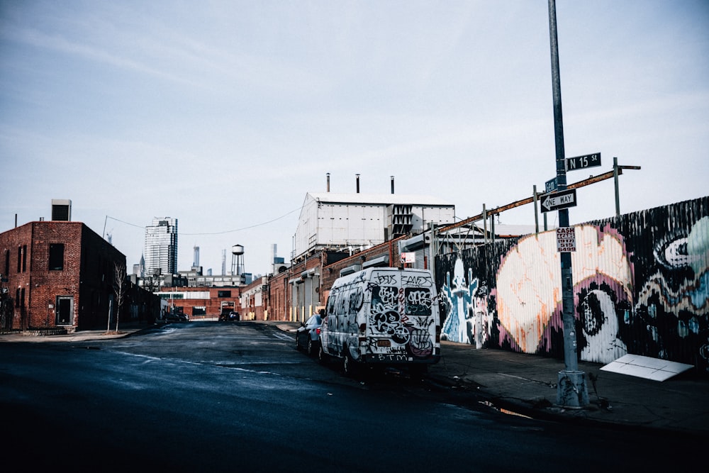 a street with graffiti on the side of buildings