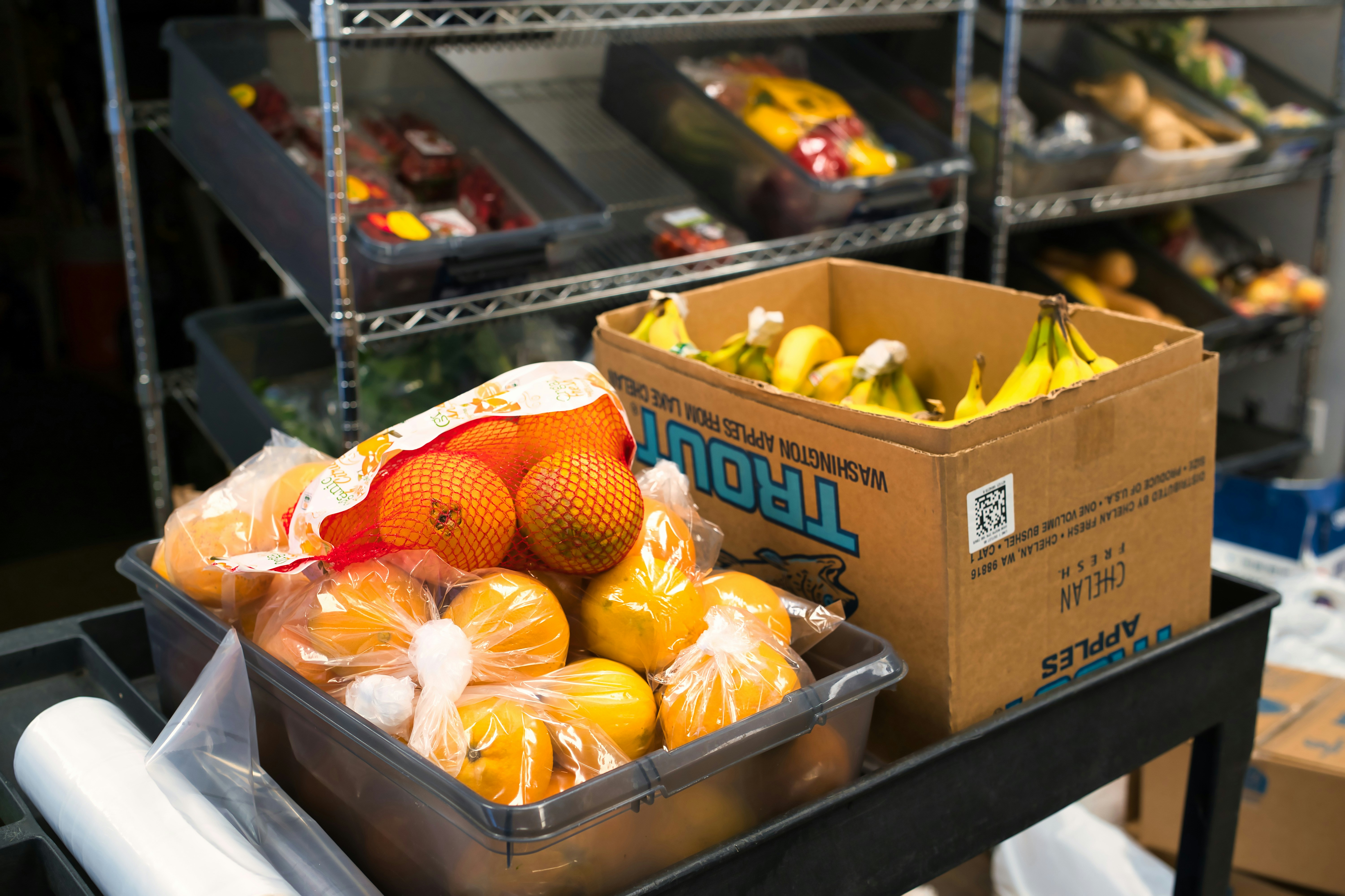 a bin full of fruit sitting on top of a table