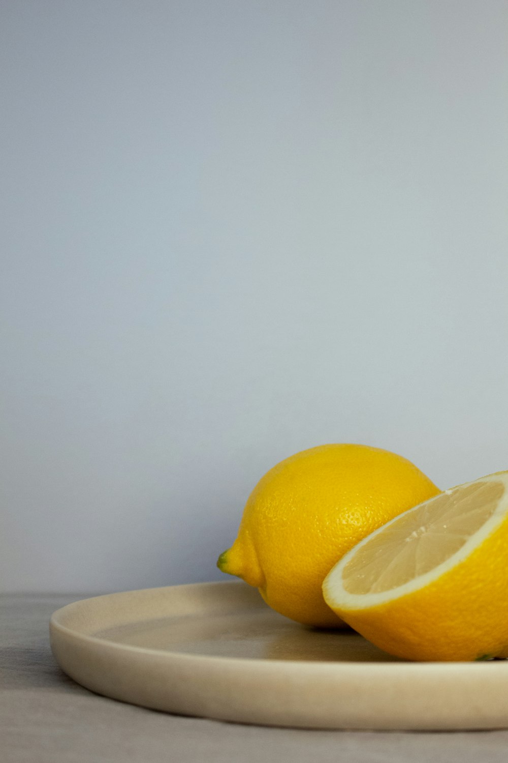 a couple of lemons sitting on top of a plate