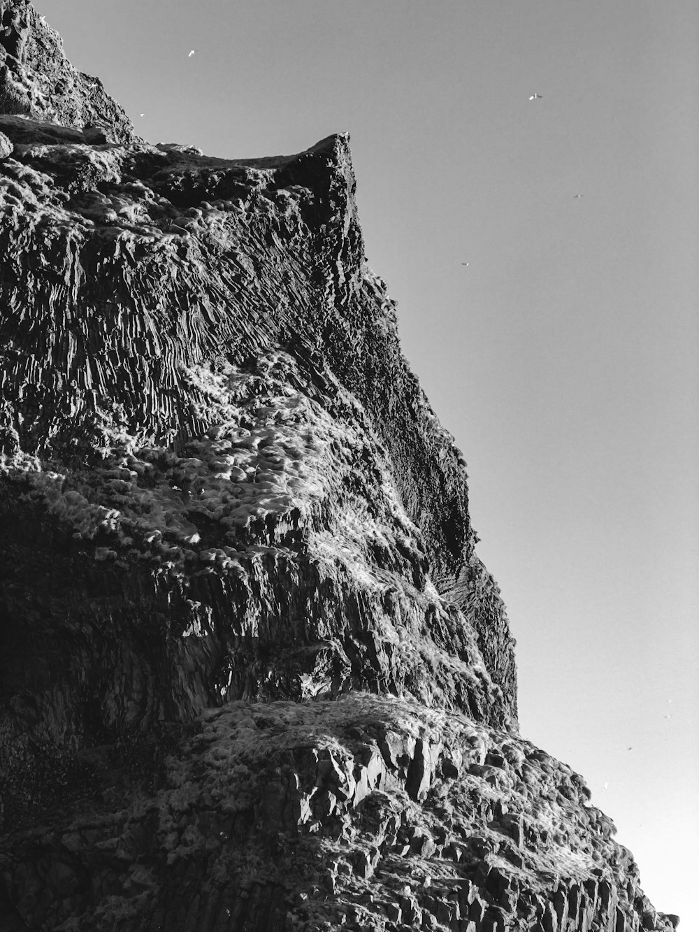 a black and white photo of a rocky mountain