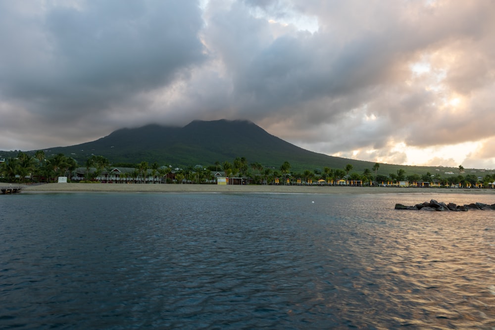 a large body of water with a mountain in the background