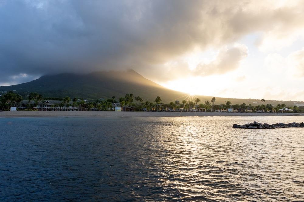 a large body of water with a mountain in the background