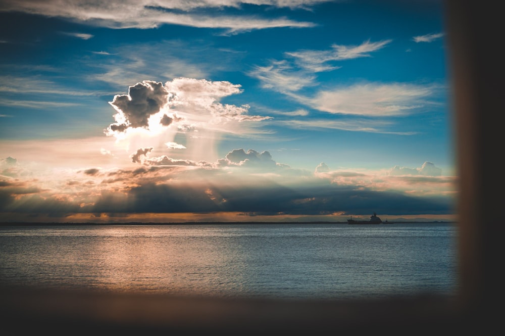 a large body of water under a cloudy sky