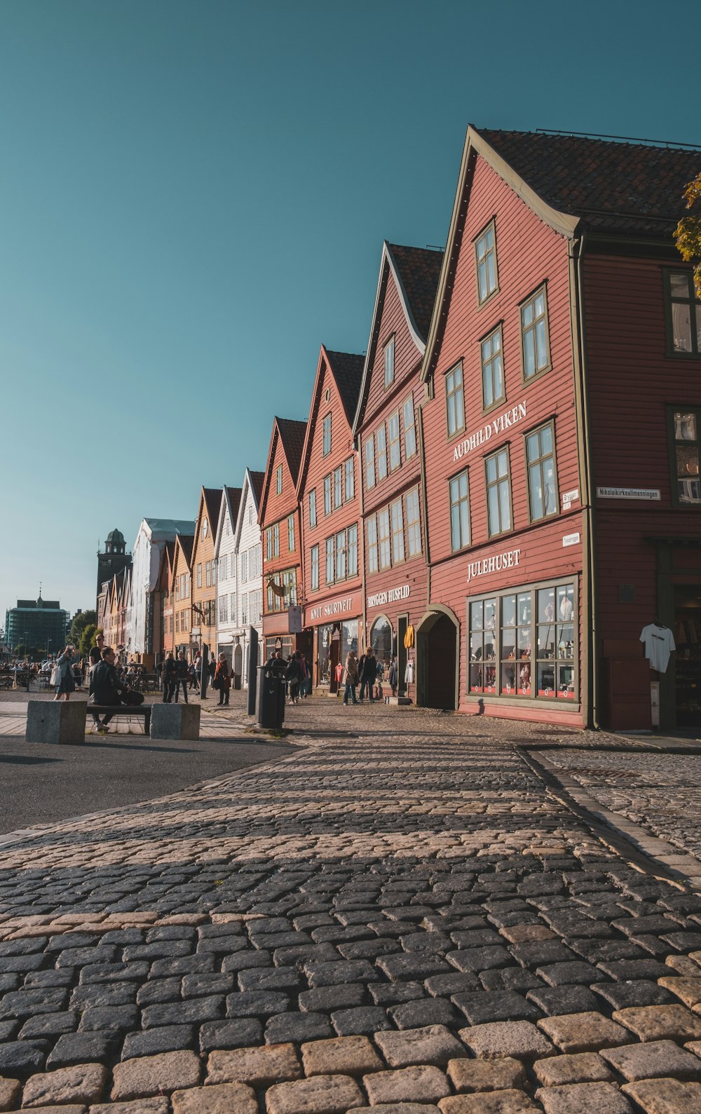 a cobblestone street lined with red buildings